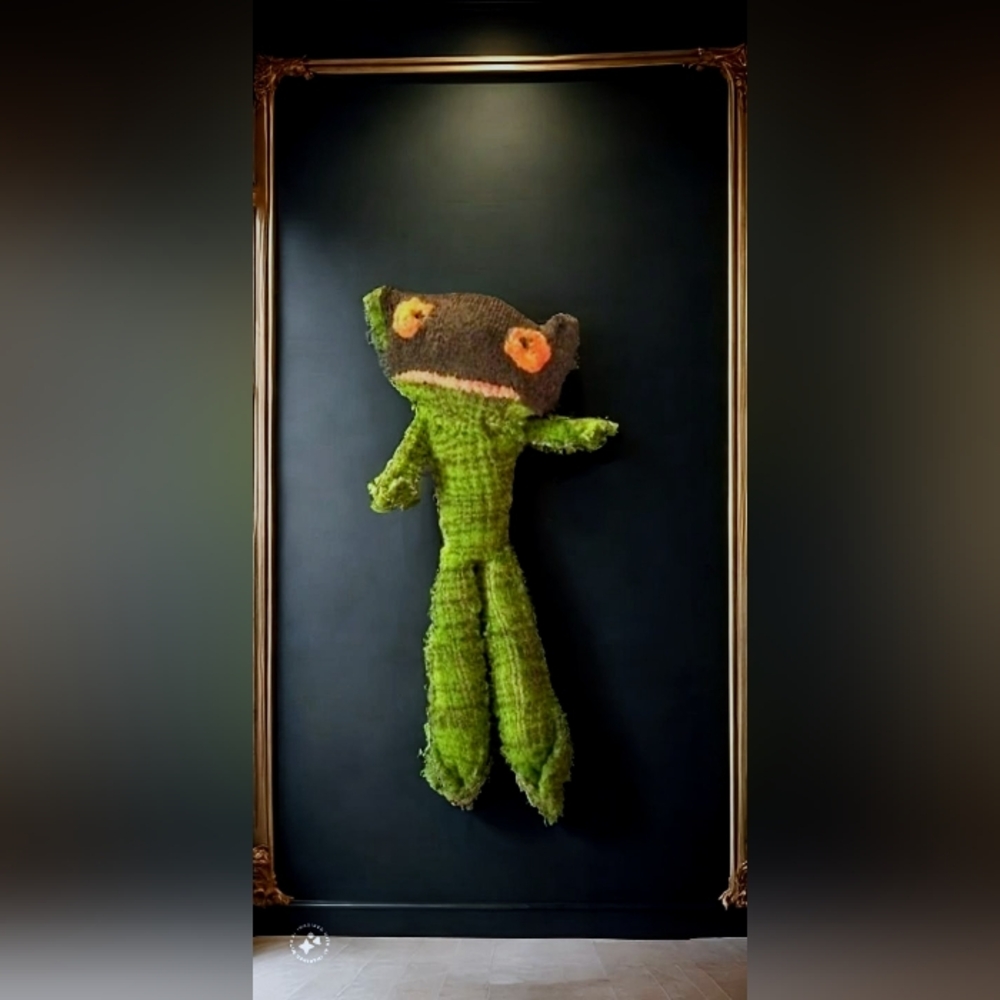 Green plushie with orange eyes